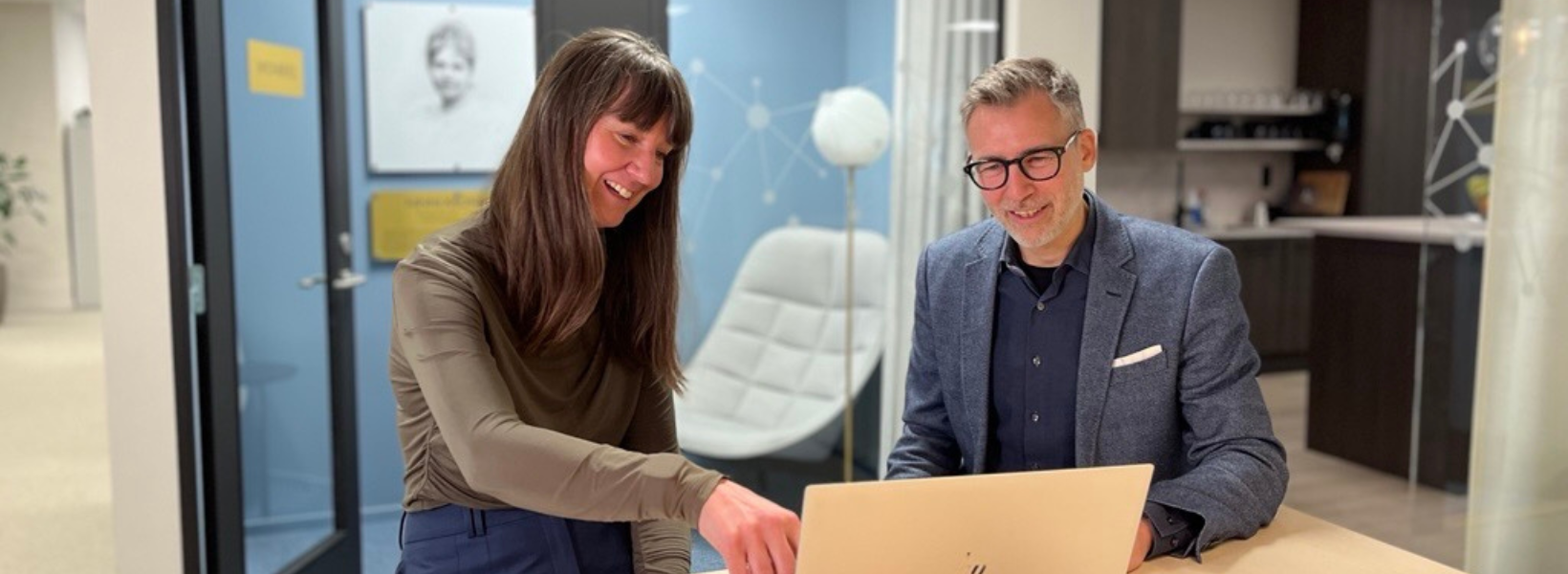 Photo of two people sitting in the office.
