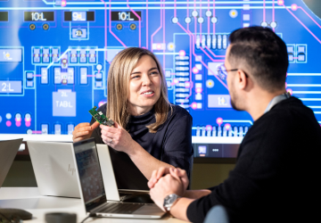 Photo of two engineers discussing design.