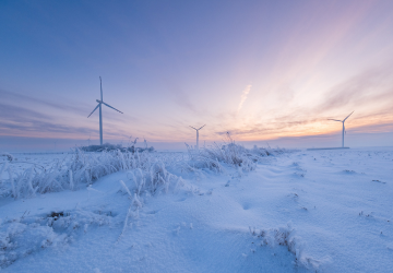 Photo of wind power plant i snowy landscape.
