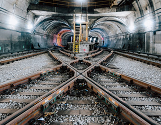 Two tunnels and train tracks crosses