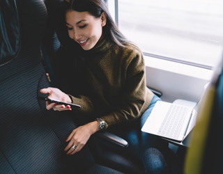 Person sitting on train smiling
