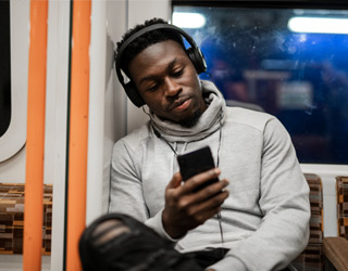 Man on subway using the internet onboard