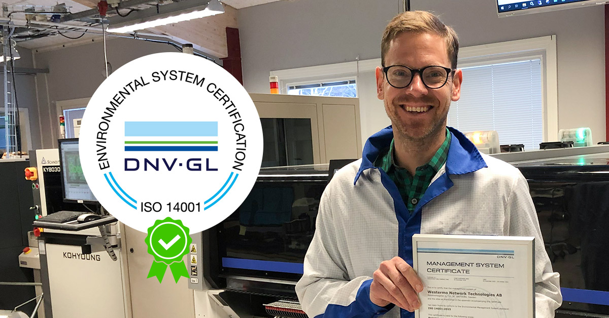 Westermo's quality manager Oscar Eklund holding the ISO 14001 certificate.