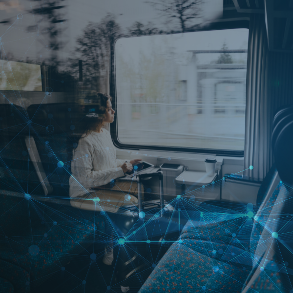 A woman with a tablet sitting in a train
